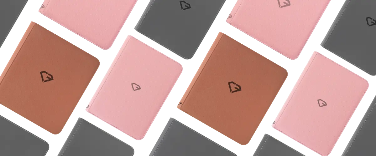 Colorful notebooks in various shades, including pink, brown, and gray, arranged stylishly on a flat surface.