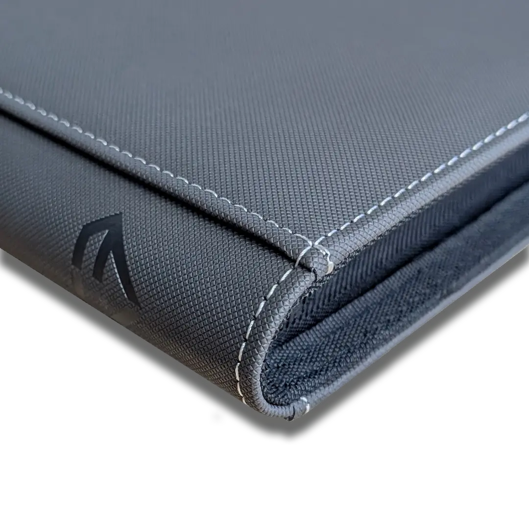 Close-up view of a stylish gray portfolio with stitched edges, featuring a sleek design and logo.