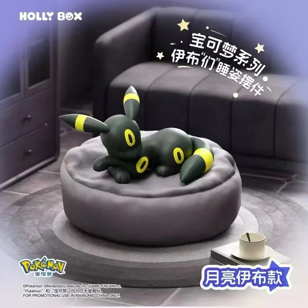 Boîte surprise Eeveelution endormie mettant en vedette une figurine Umbreon endormie sur un coussin douillet.