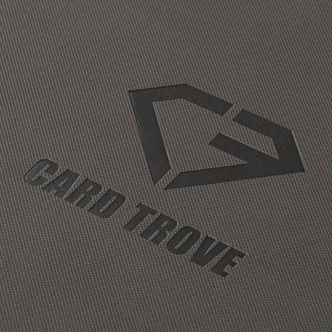 9-Pocket Toploader Card Binder - Trove Limited surface detail and logo on grey textured binder.