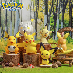 Togedemaru Figure among various Pokémon figures on tree stumps in a forest setting.