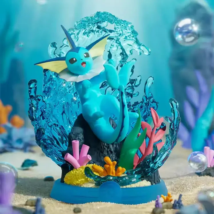 Détendez-vous et profitez de la boîte surprise Evee mettant en vedette Vaporeon dans un diorama sous-marin vibrant avec des coraux colorés.