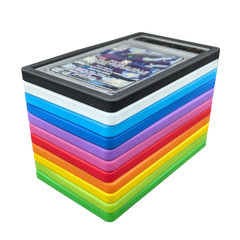 PSA Slab Bumper - Black, PSA Slab Bumper - White, PSA Slab Bumper - Purple, PSA Slab Bumper - Red, PSA Slab Bumper - Green, PSA Slab Bumper - Light Green, PSA Slab Bumper - Blue, PSA Slab Bumper - Light Blue, PSA Slab Bumper - Yellow, PSA Slab Bumper - Orange, PSA Slab Bumper - Pink displayed among other colorful bumpers for graded card protection.